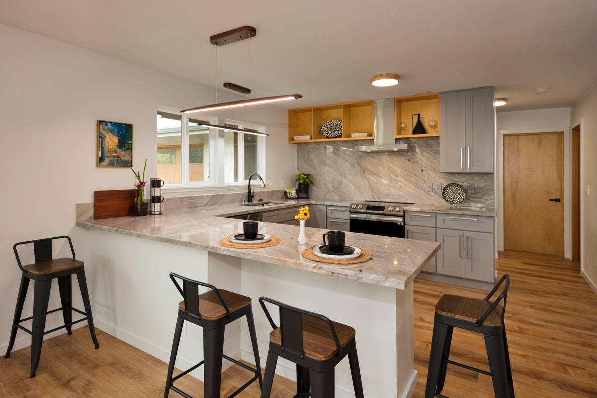 Spacious bright and open kitched featuring custom fabricated counters  from solid slabs of granite.  Note high end ultra modern
High lumen LED light fixtures.