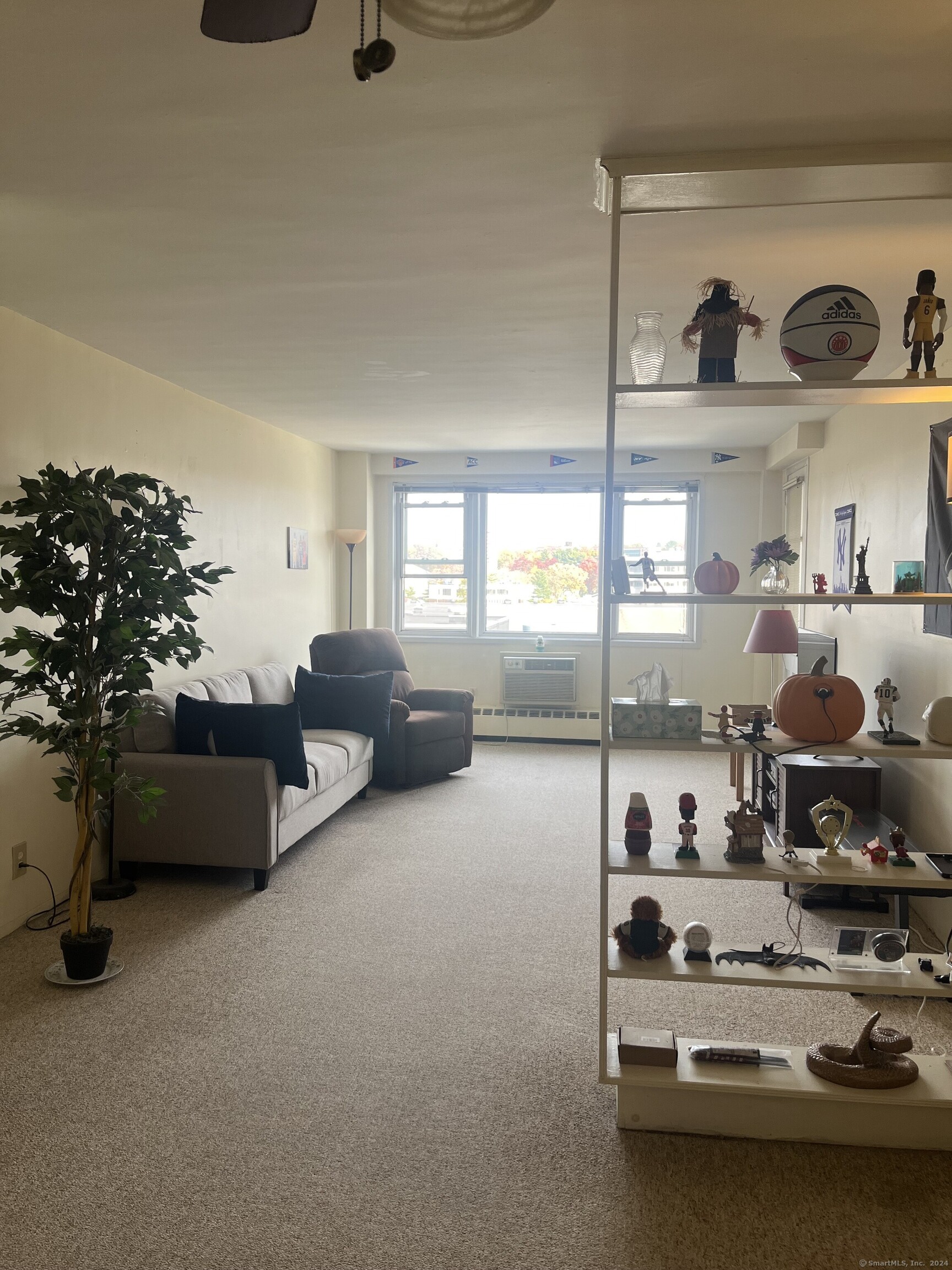 a living room with furniture and a floor to ceiling window