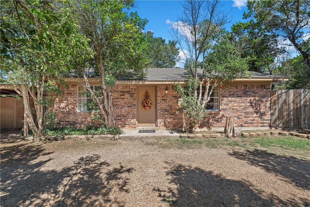 a view of a backyard with large trees