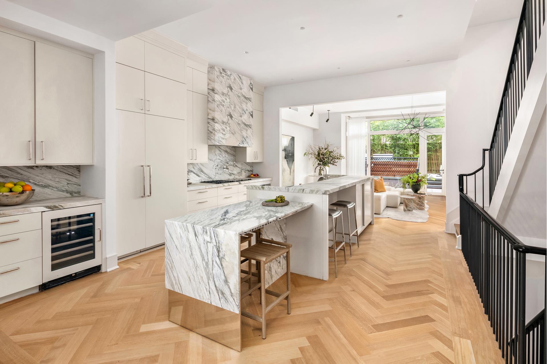 a kitchen with kitchen island a stove a sink and a refrigerator