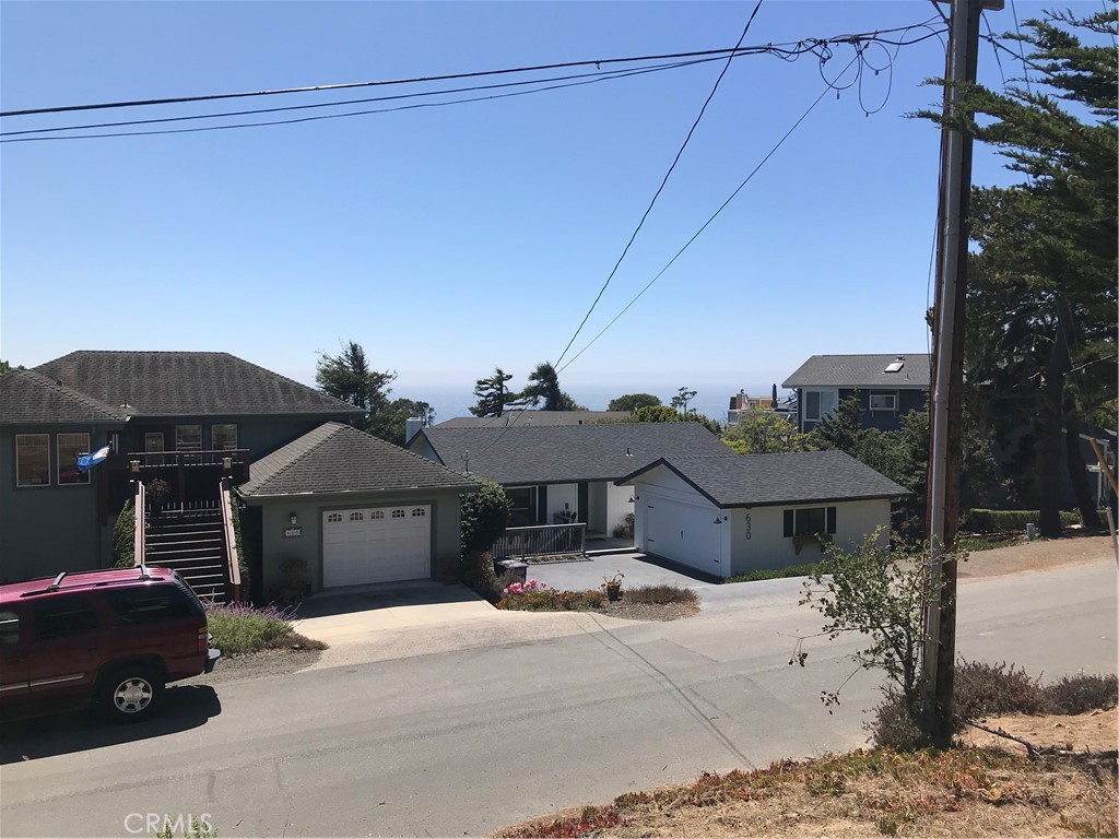 a front view of a house with parking space