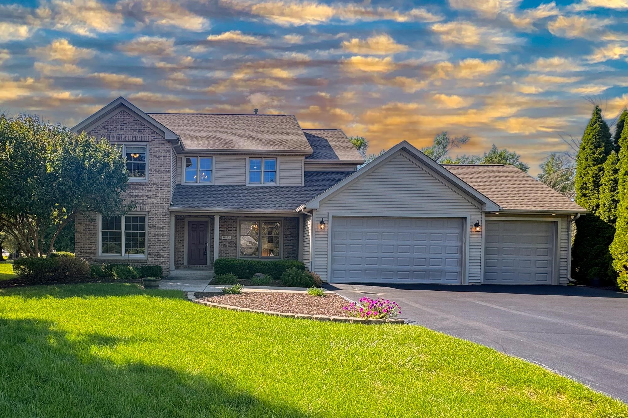 a front view of house with yard and green space