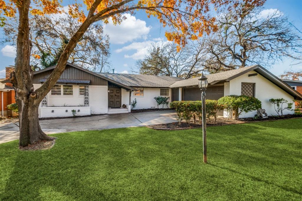 a front view of house with yard and green space