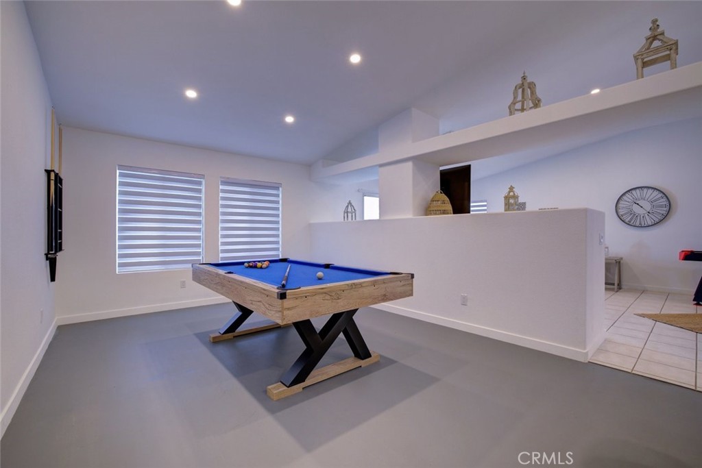 a room with furniture pool table and window