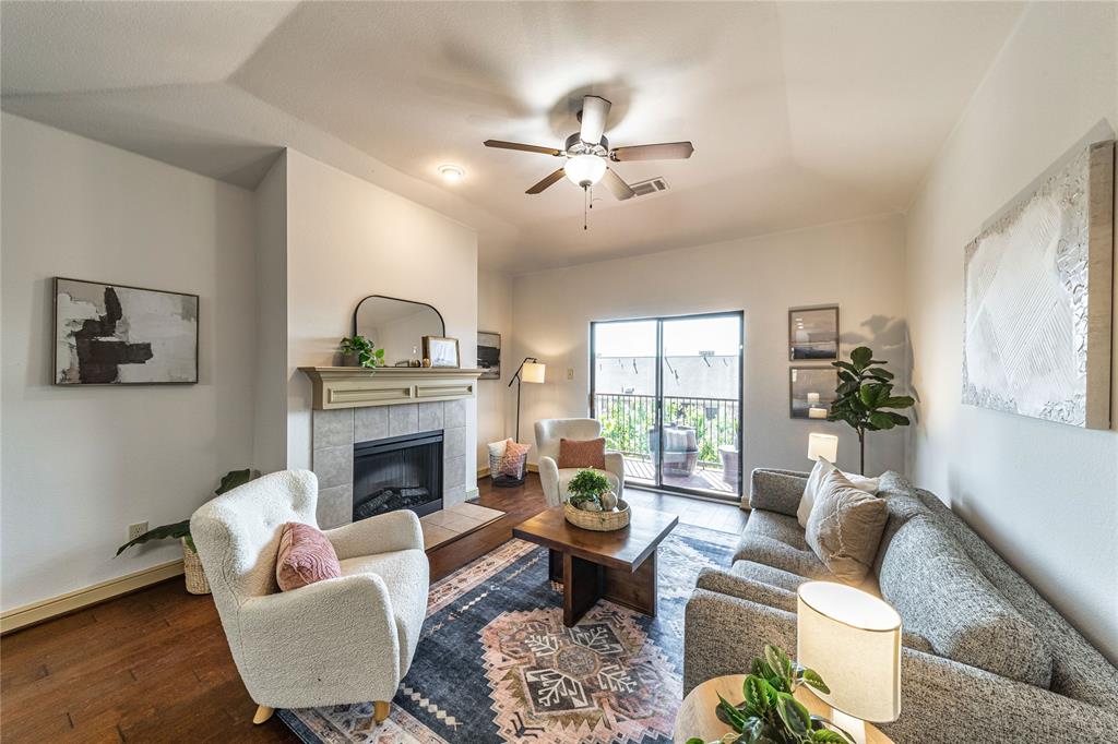 a living room with furniture fireplace and a window