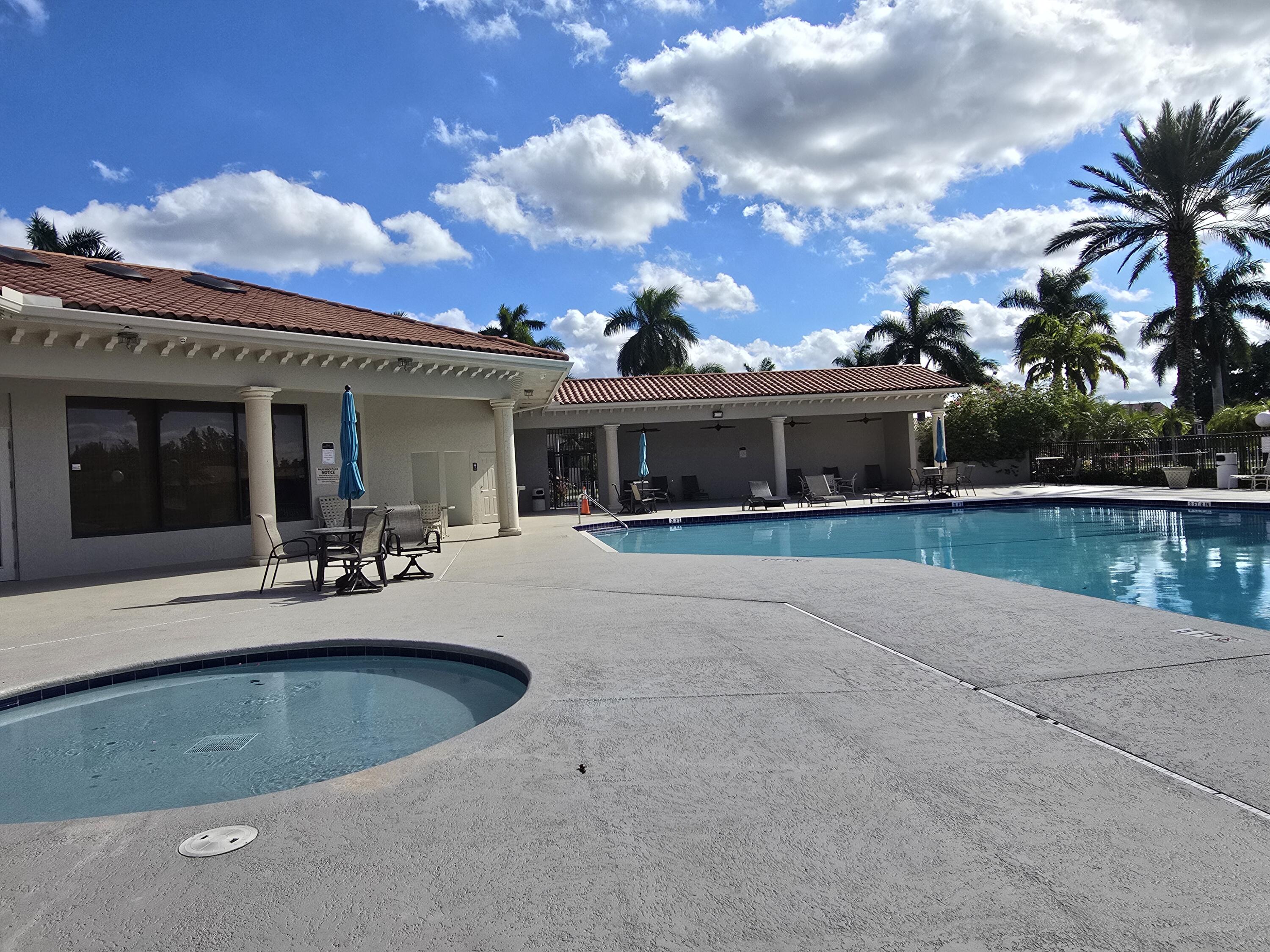 a view of a house with swimming pool and a yard