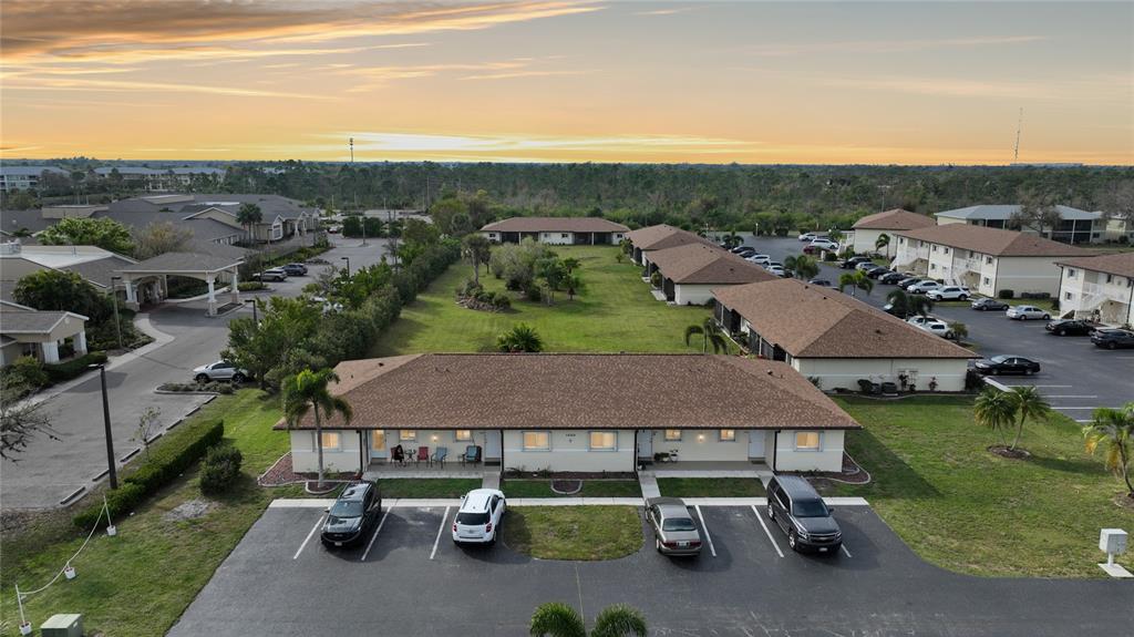 an aerial view of a house with swimming pool and outdoor seating