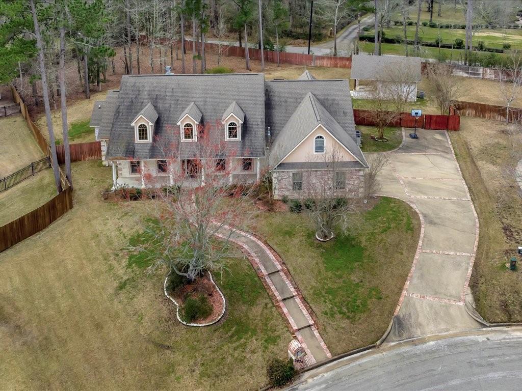 an aerial view of a house with garden space and sitting area