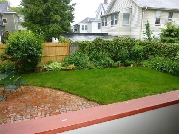 a front view of a house with a garden and yard