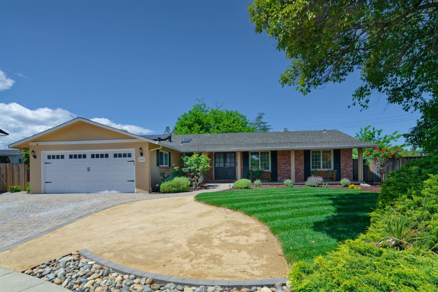 a front view of a house with a garden