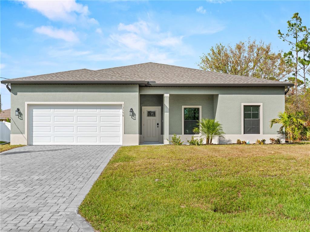 a front view of a house with a yard and garage