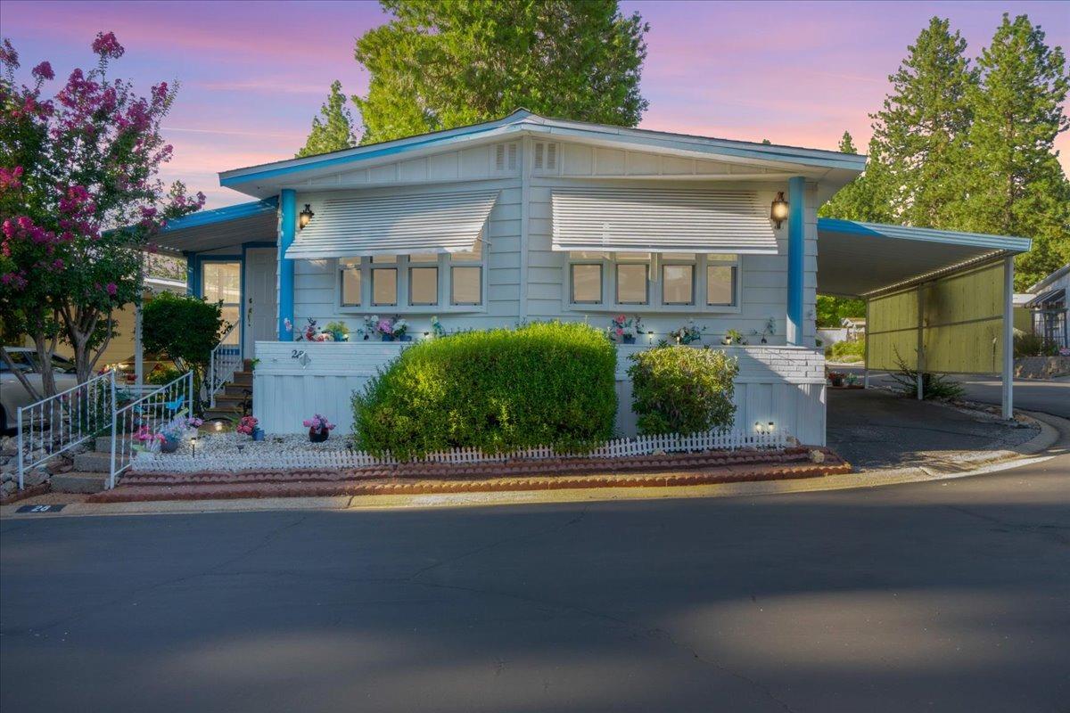 a front view of a house with a garden