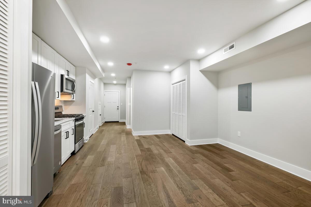 a view of a refrigerator in kitchen and wooden floor