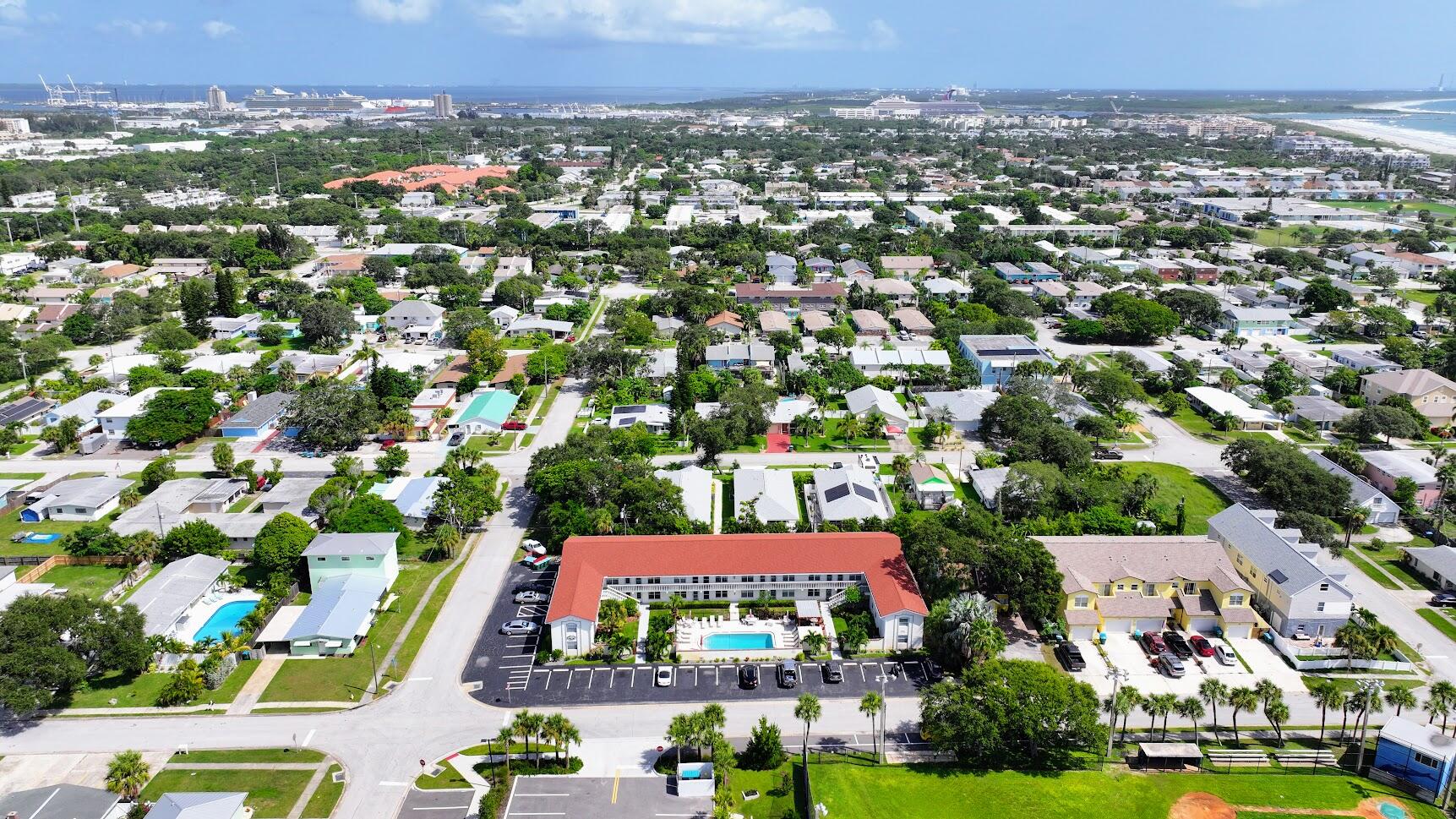 an aerial view of residential houses with outdoor space and swimming pool