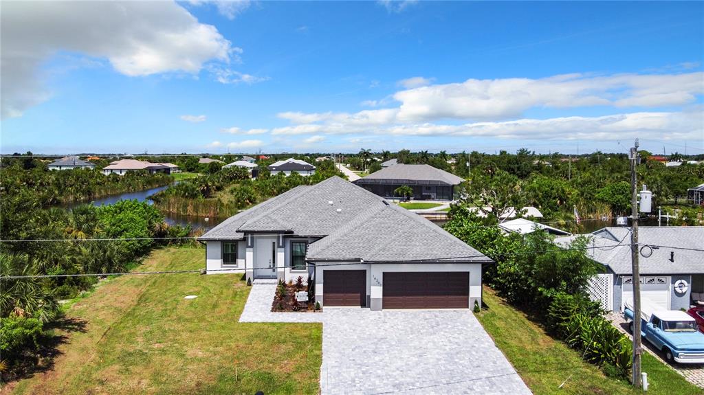 a aerial view of a house next to a yard