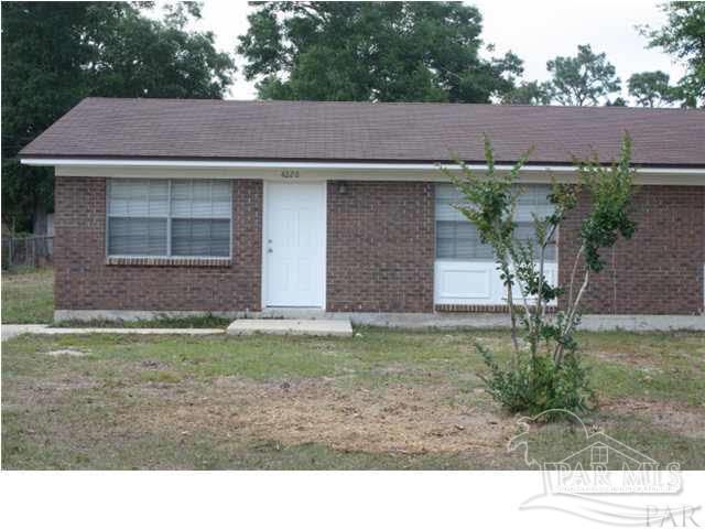 a view of a house with a yard and plants