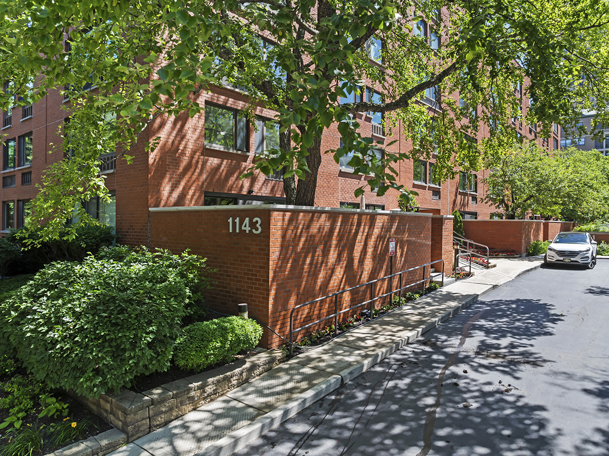 a view of a street with wooden fence