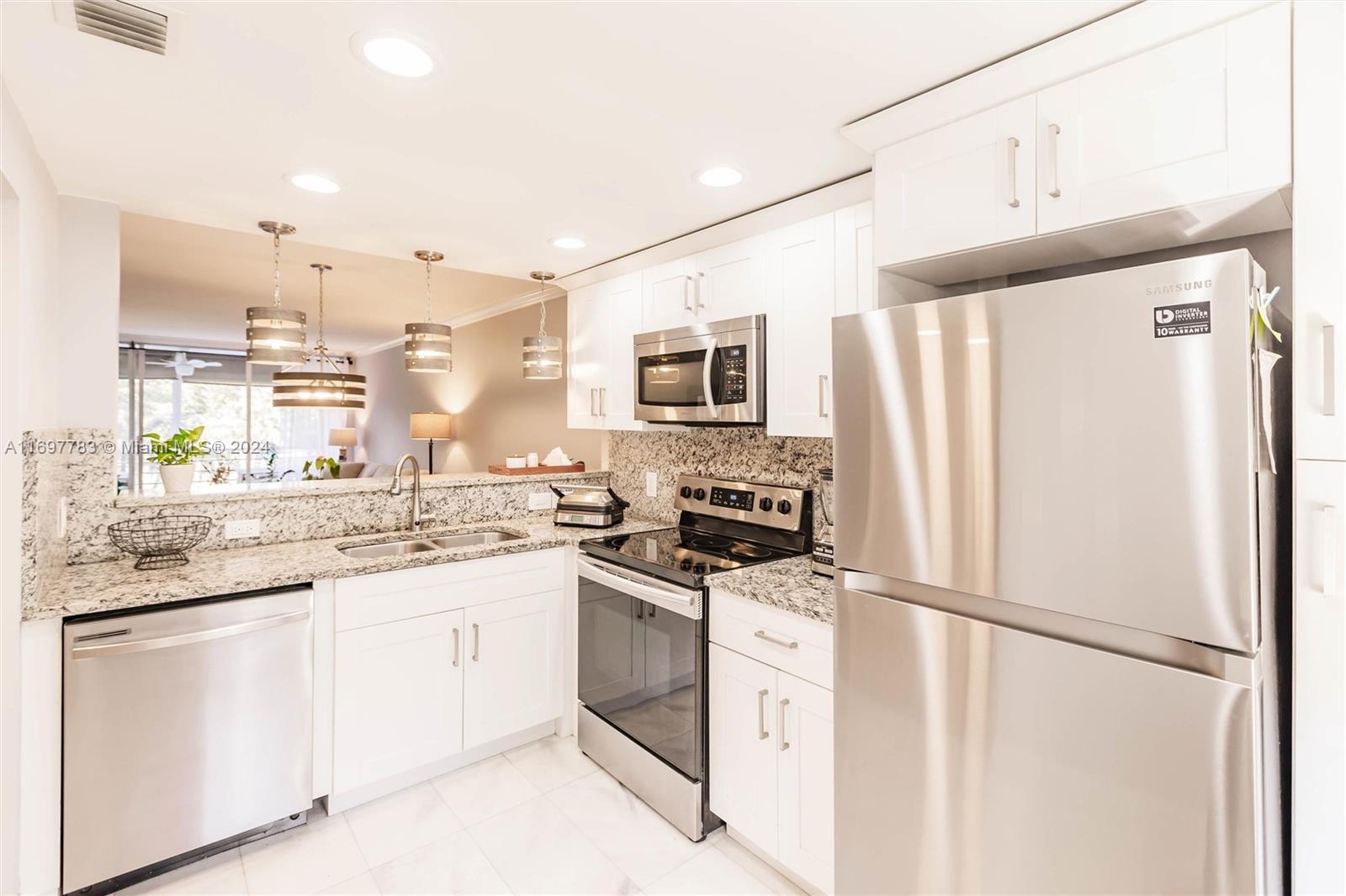 a kitchen with stainless steel appliances a refrigerator sink and microwave