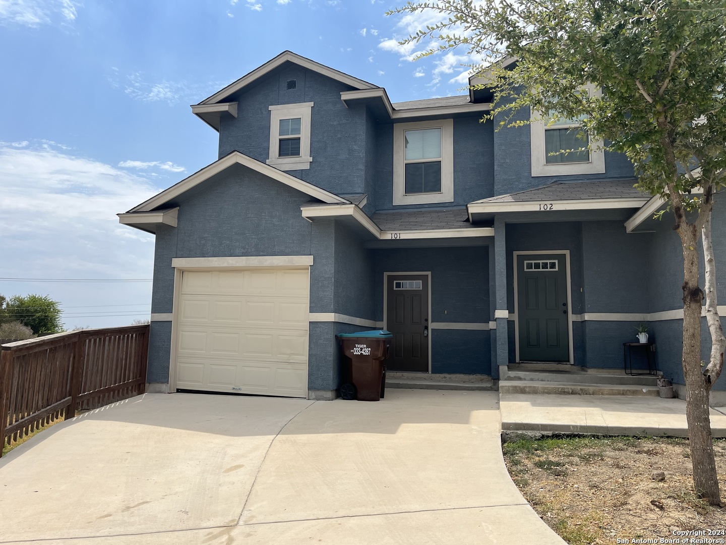 a front view of a house with a garage