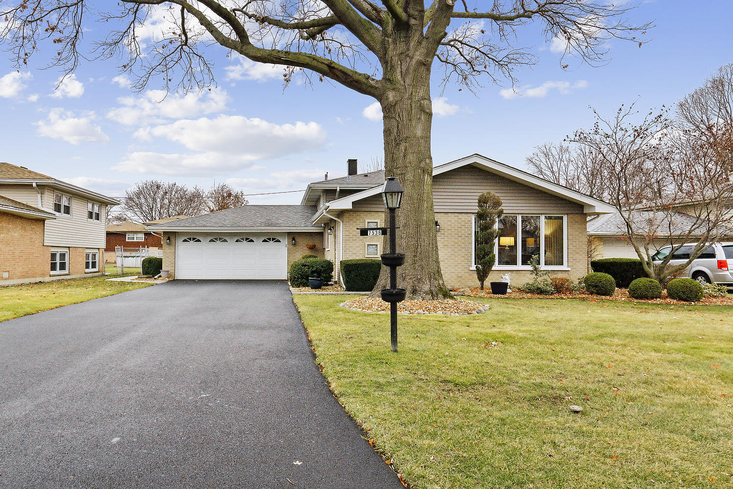 a front view of a house with a yard and garage