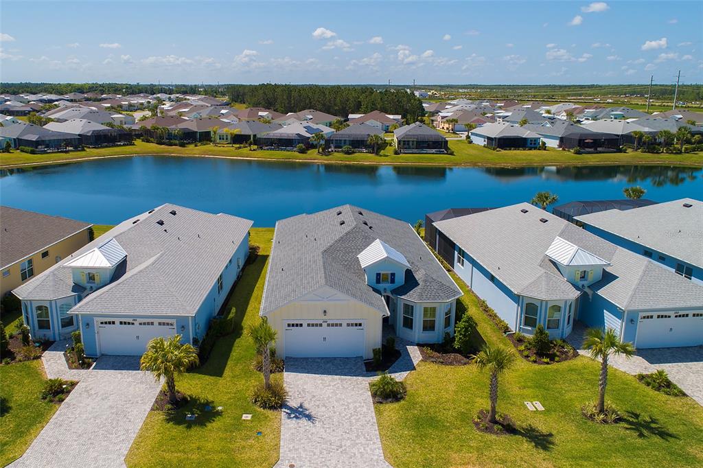 an aerial view of a house with a swimming pool outdoor seating and yard