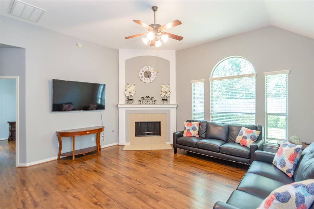 a living room with furniture fireplace and flat screen tv