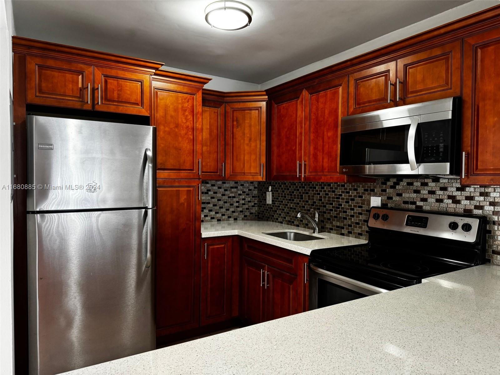 a kitchen with stainless steel appliances a refrigerator and a sink