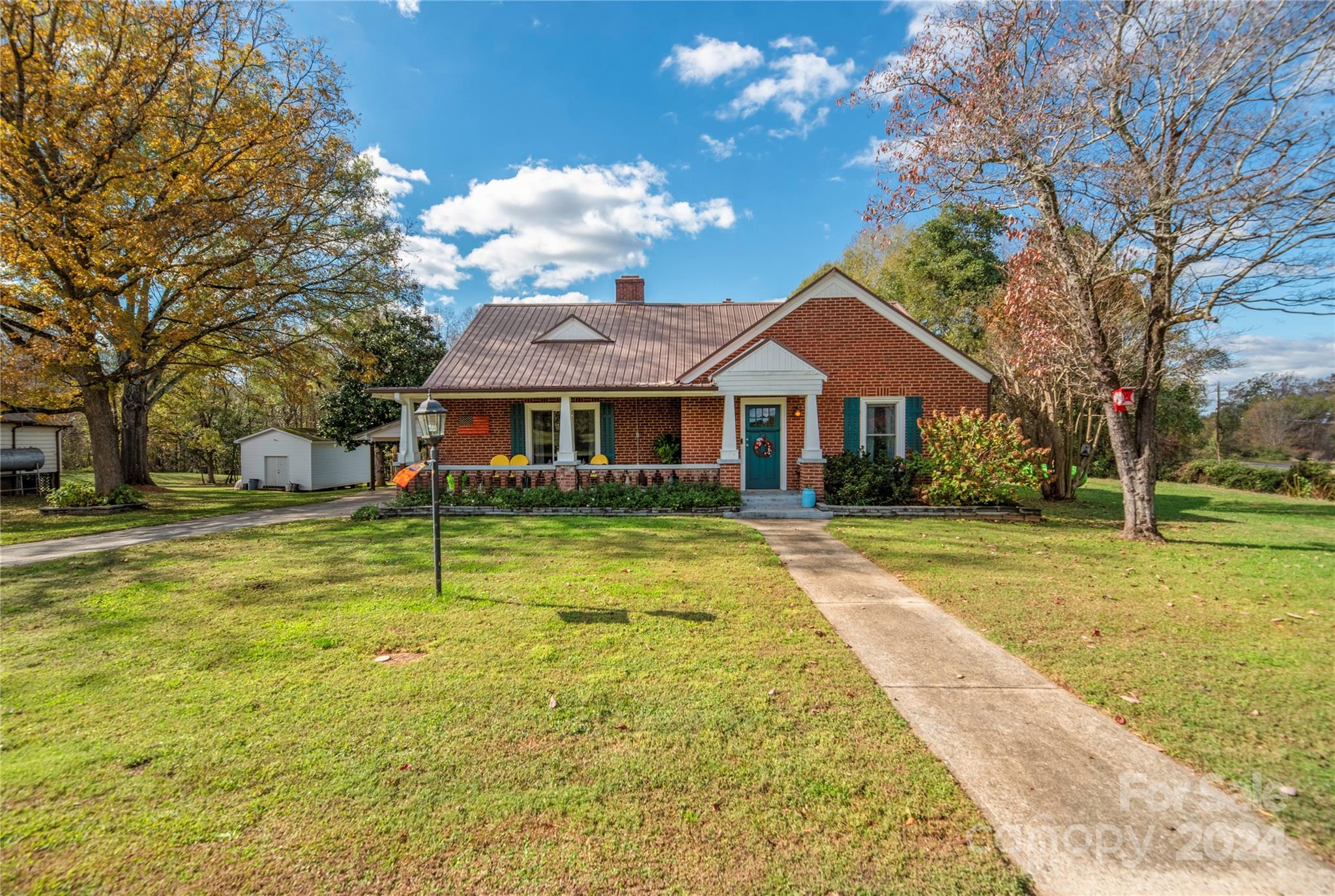 a front view of house with yard and swimming pool