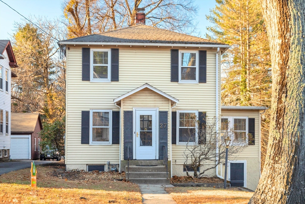 a front view of a house with garden