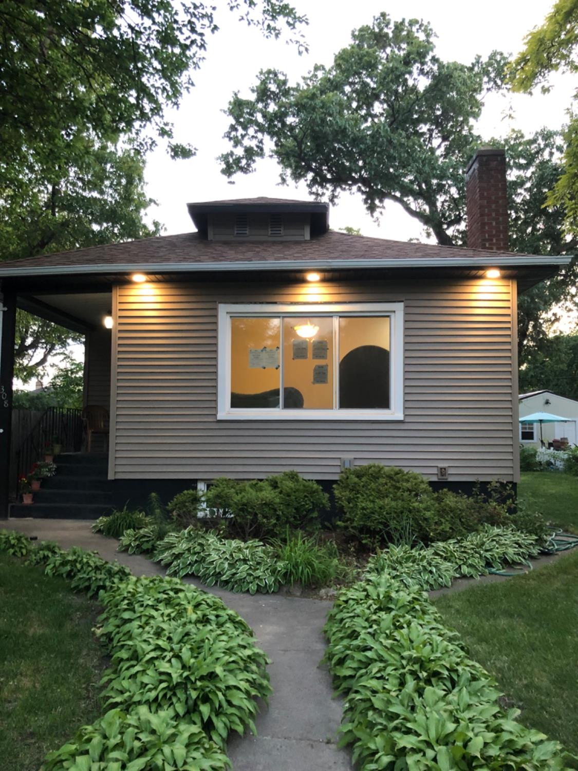 a front view of a house with garden