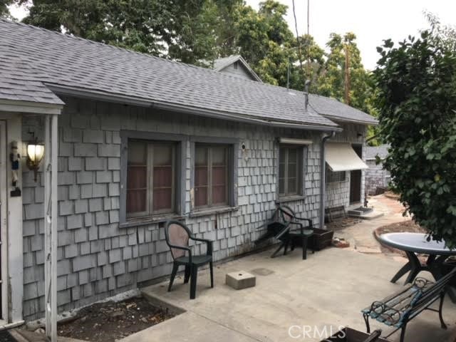 a brick house with table and chairs in front of it