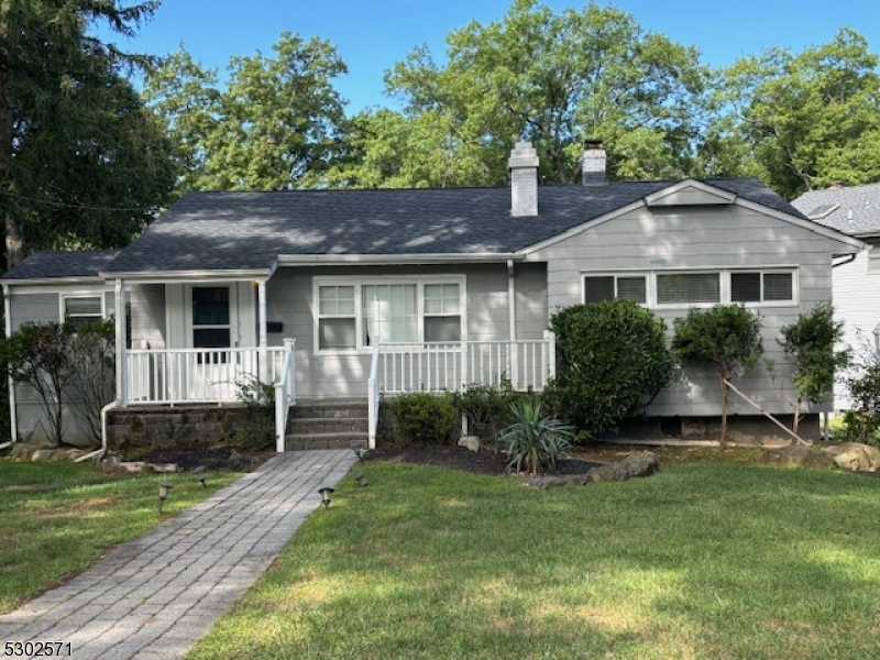 a front view of a house with a yard and porch