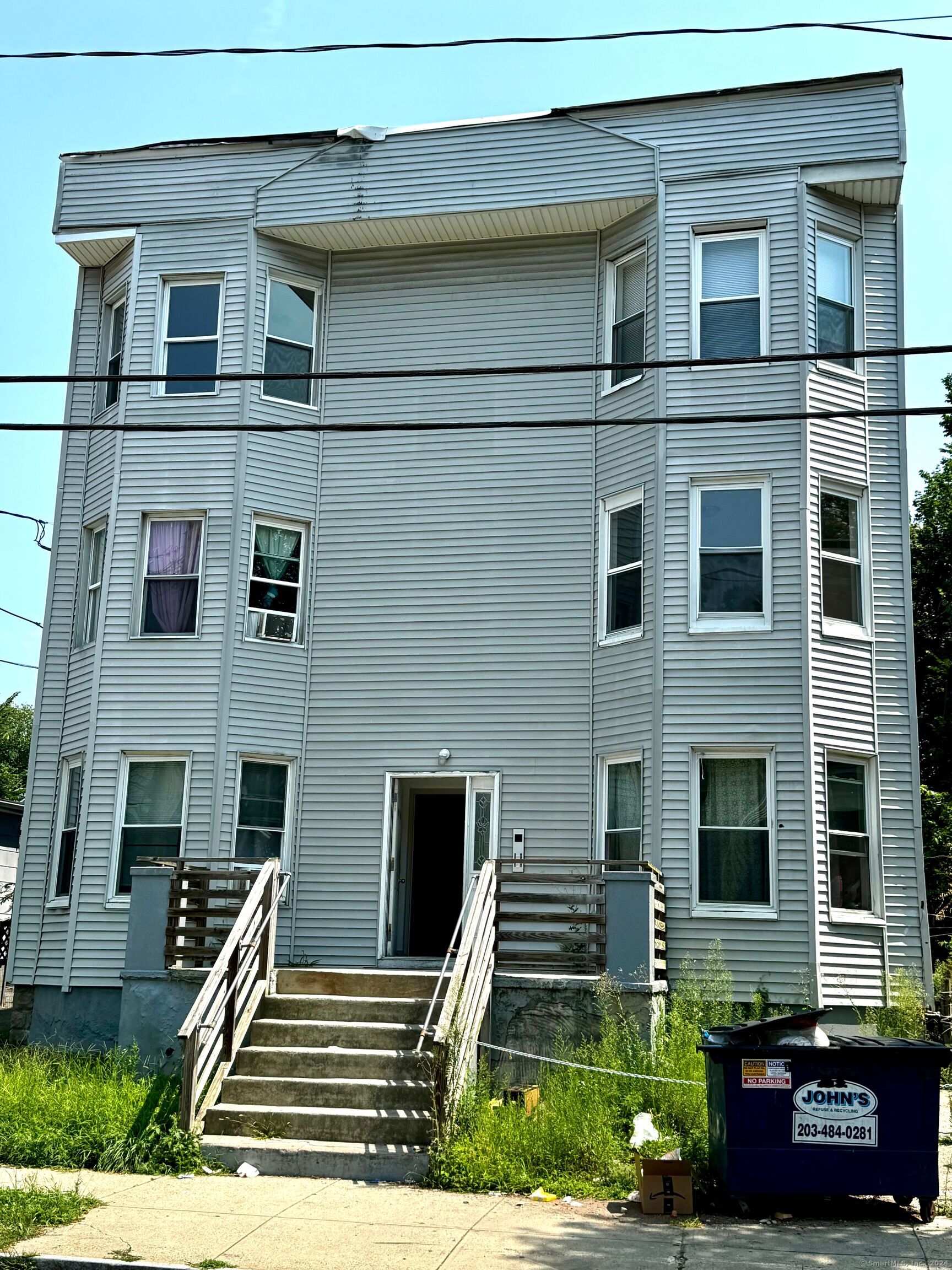 a front view of a house with lots of windows