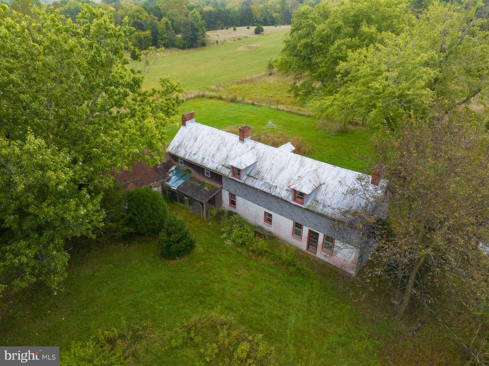 a view of a house with a yard from a lake view