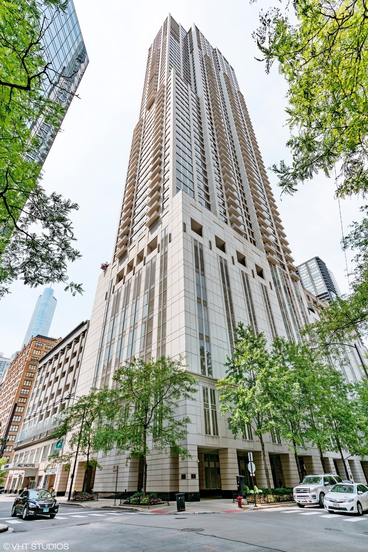 a view of a tall building next to a road