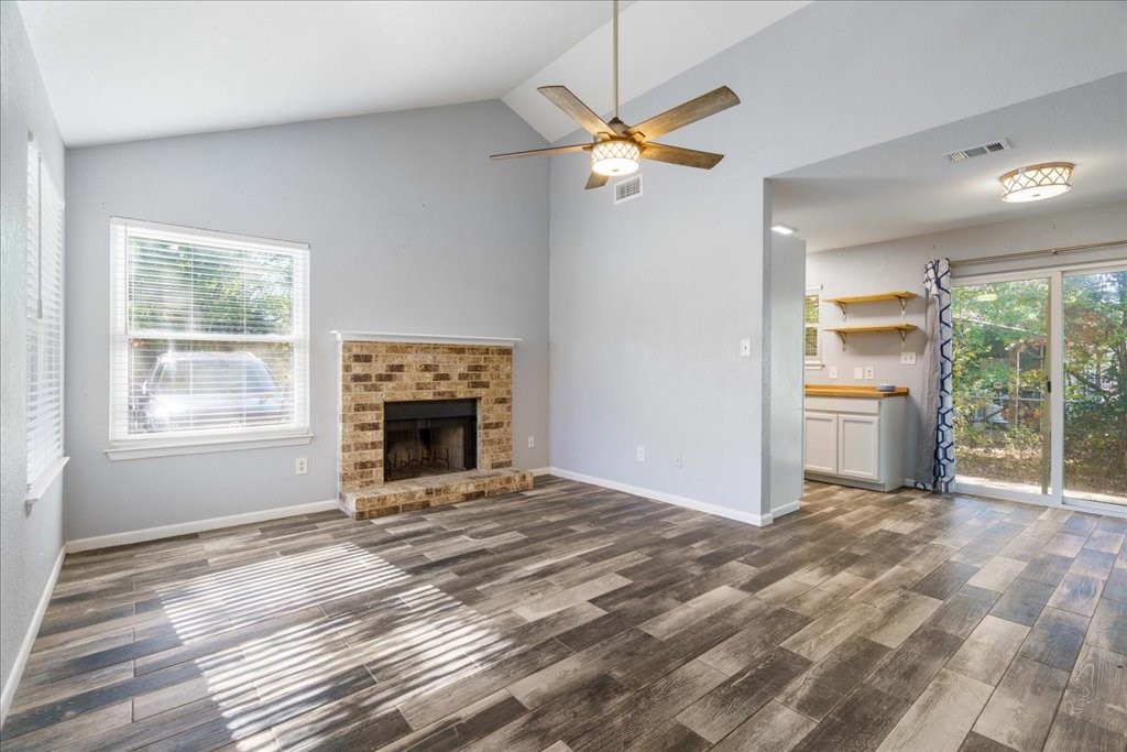 An open and airy interior featuring high ceilings and beautiful vinyl plank flooring throughout.