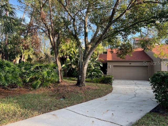 a front view of a house with a yard and a garage