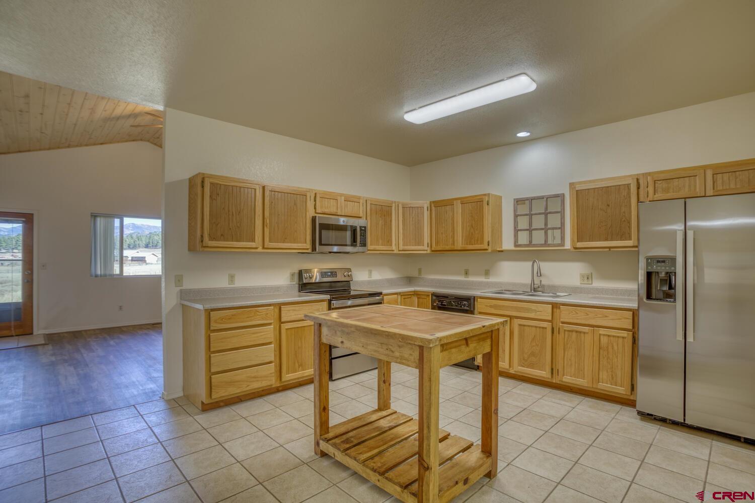 a kitchen with a sink a counter top space and appliances