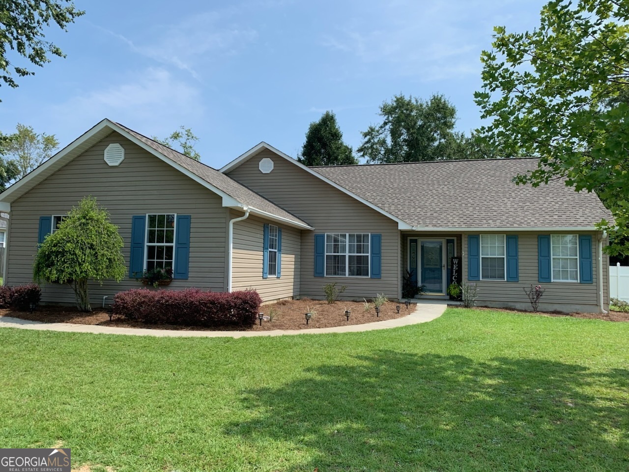 a front view of house with yard and green space