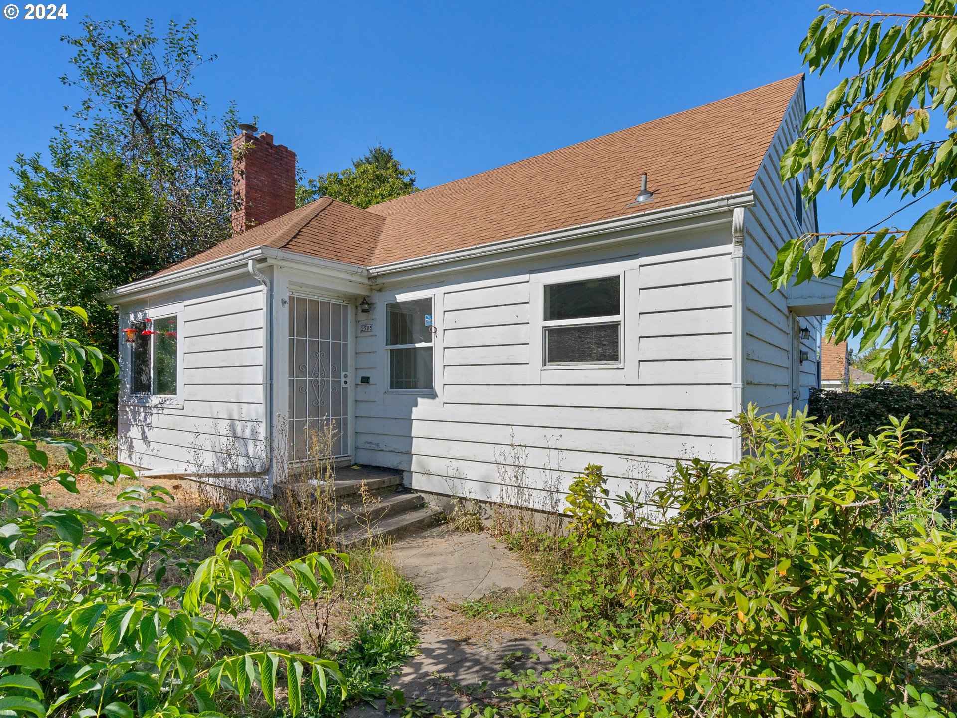 a view of a house with a yard and sitting area