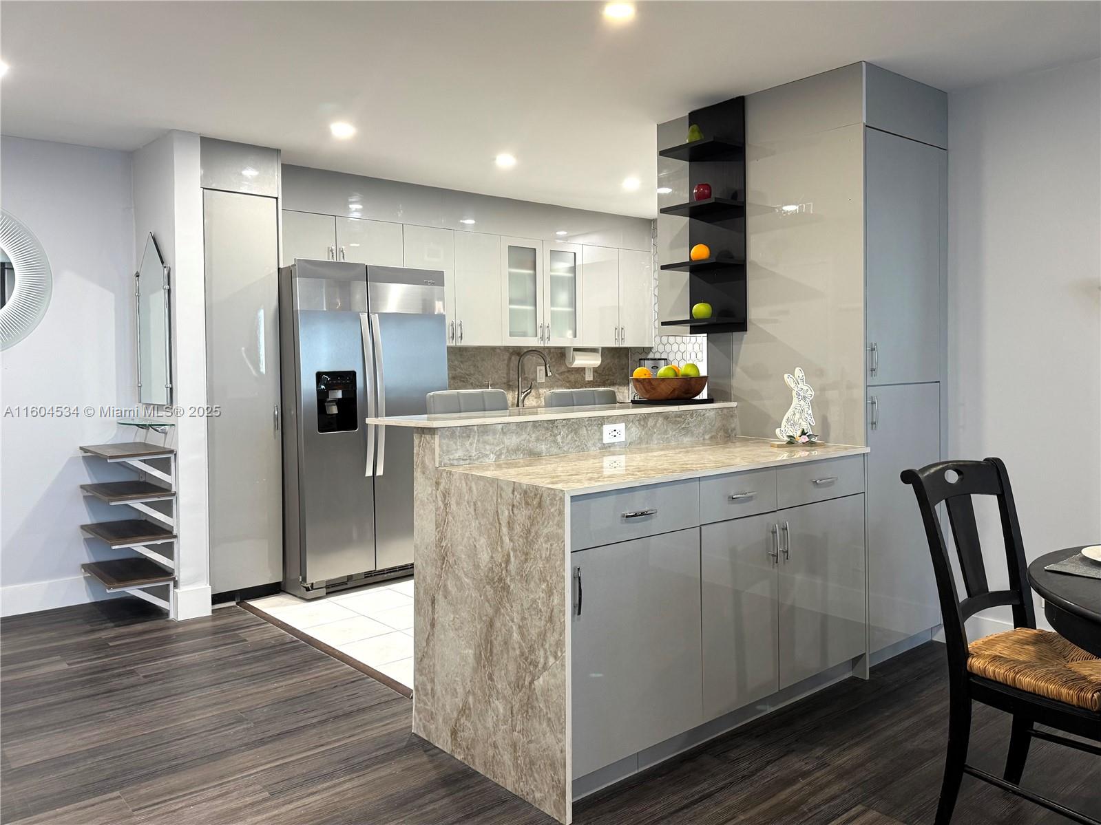 a kitchen with a refrigerator and a sink