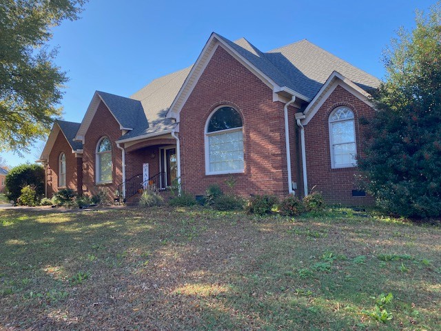 a front view of a house with a yard