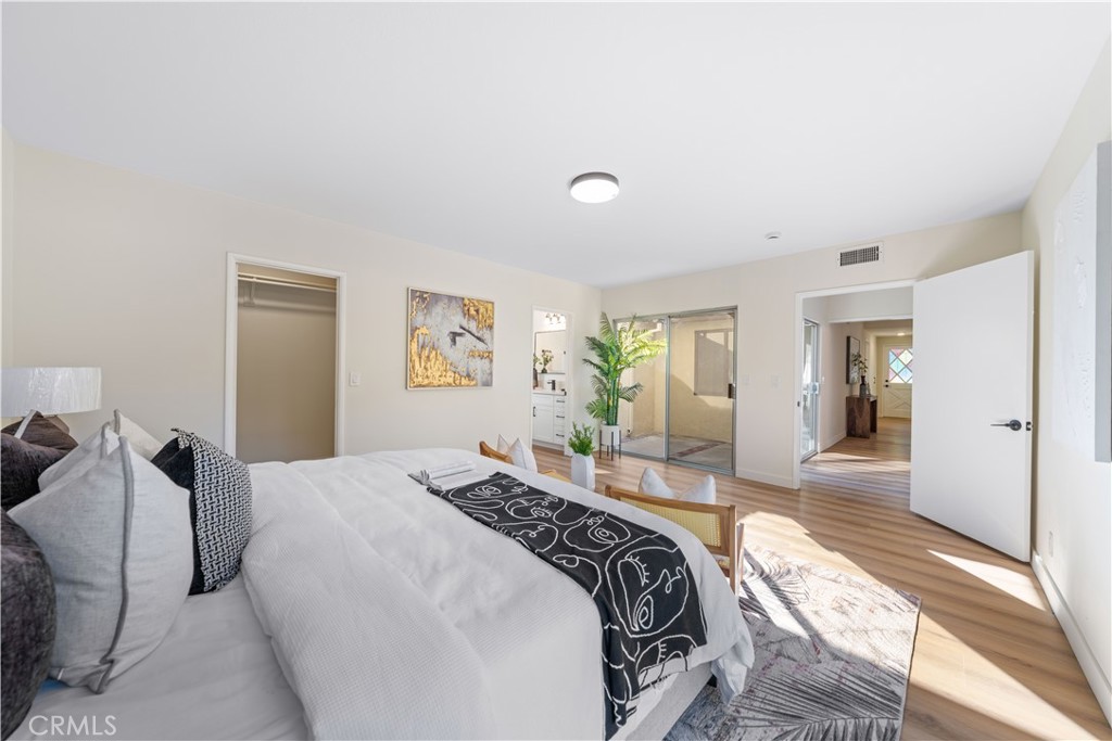 a bedroom with a bed and glass windows