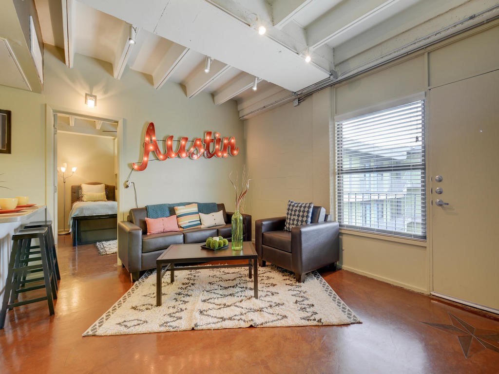 a living room with furniture and a rug