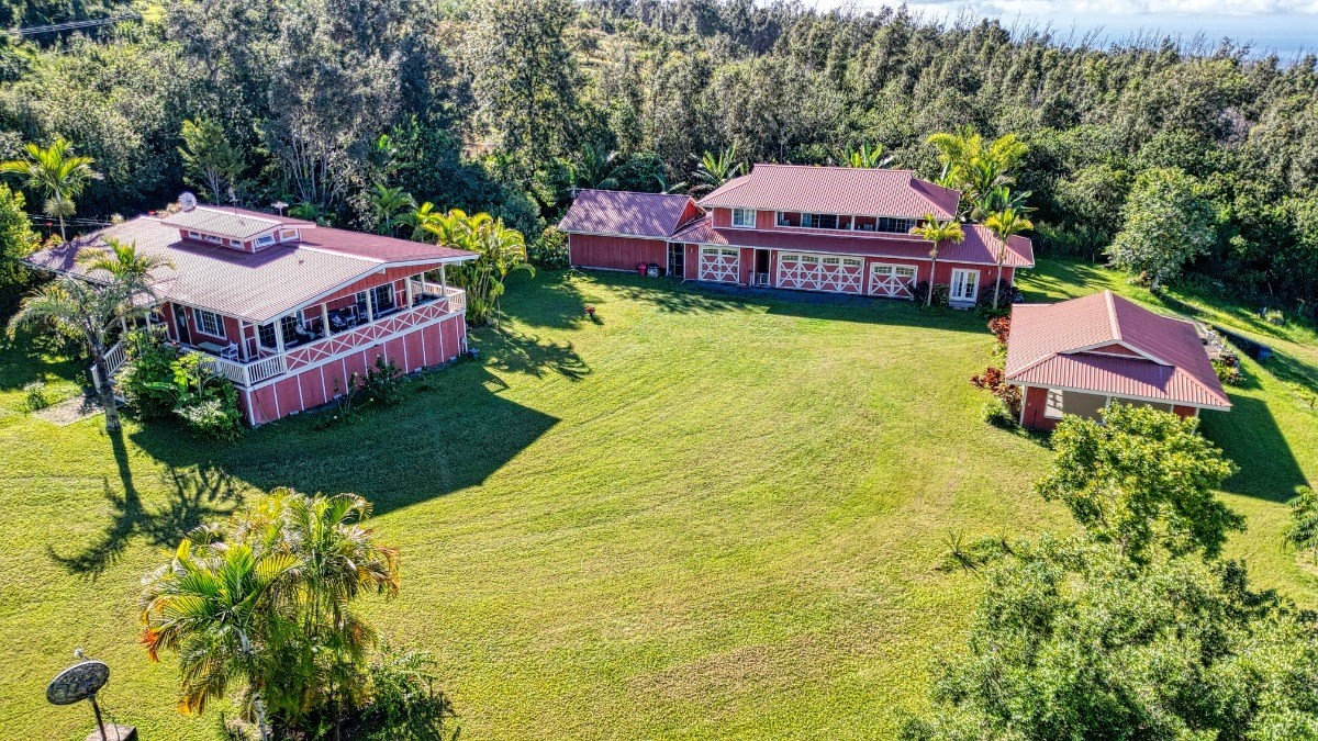 a aerial view of a house with swimming pool and yard