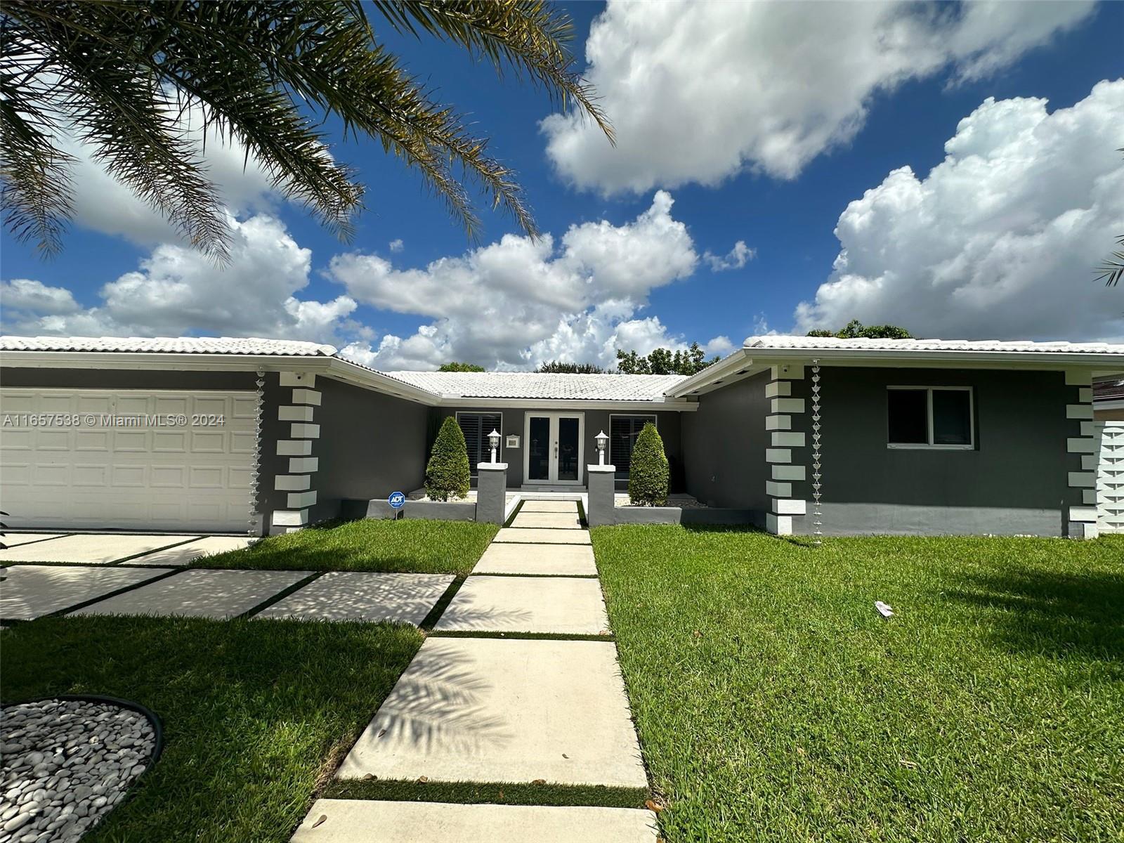 a front view of house with yard and green space