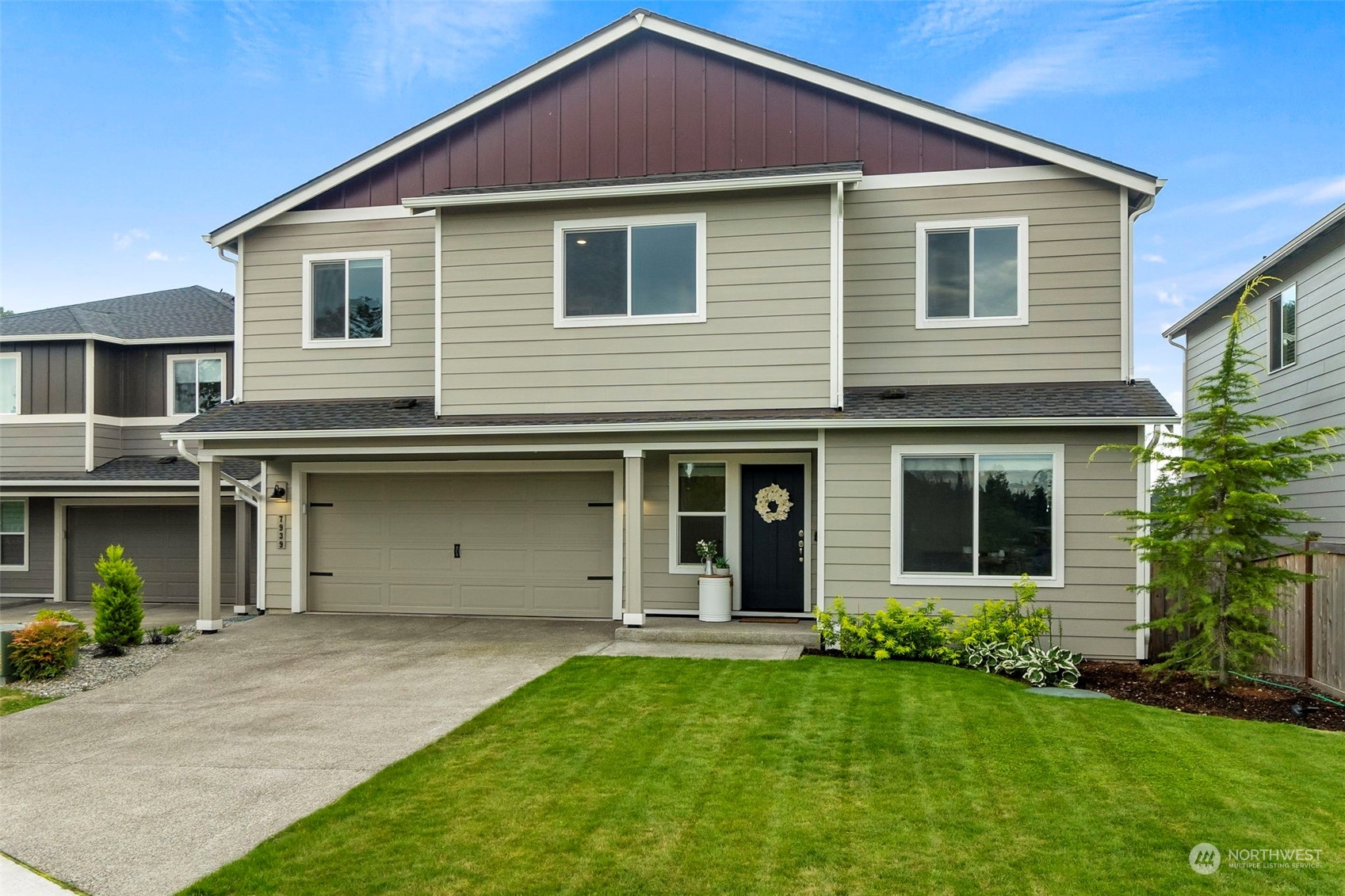 a front view of a house with a yard and garage