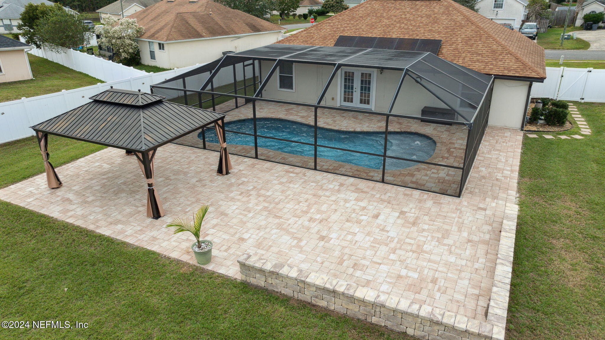 a view of a house with backyard and sitting area