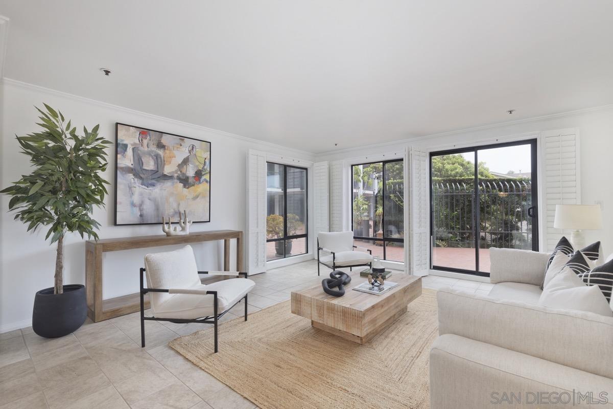 a living room with furniture and a large window with outer view