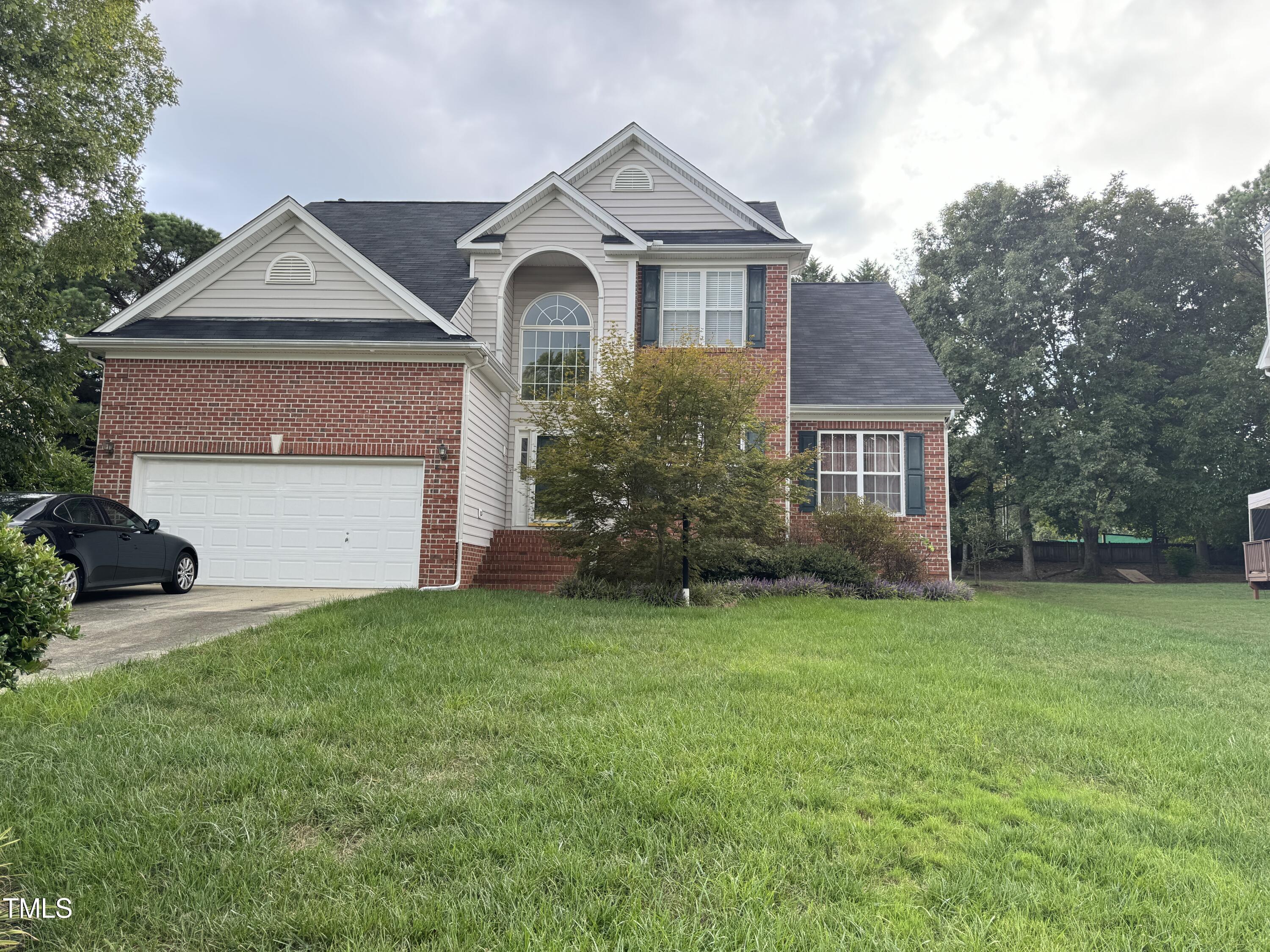 a front view of a house with a yard and garage